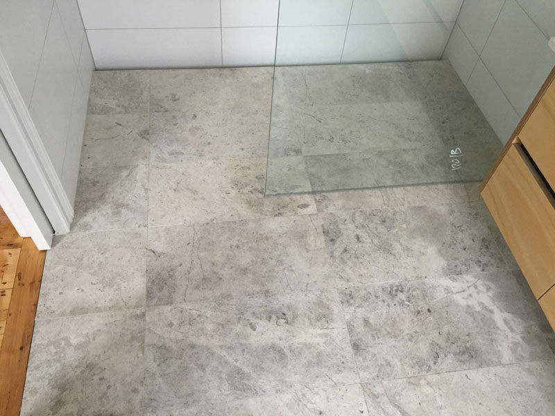 Elegantly polished marble-tiled shower area by Waterside, Penrith’s renowned tiling specialists