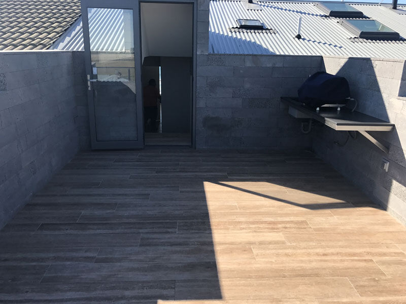 Rooftop entertainment area with wood-look tiling in Penrith, perfect for gatherings and BBQs